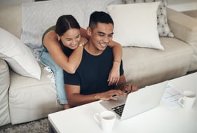 couple laughing at emails